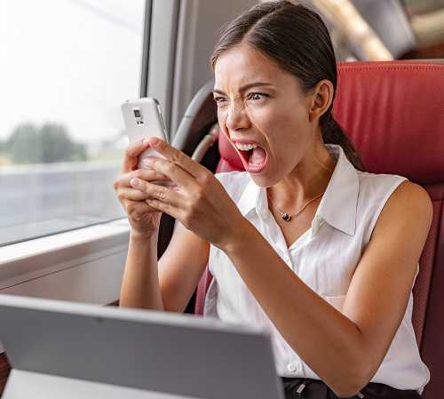 Angry Asian business woman upset screaming at phone call for com